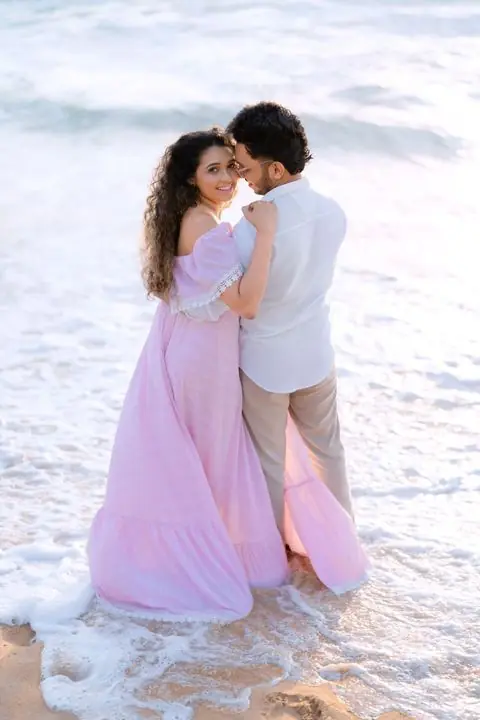 A couple on the beach at sunset