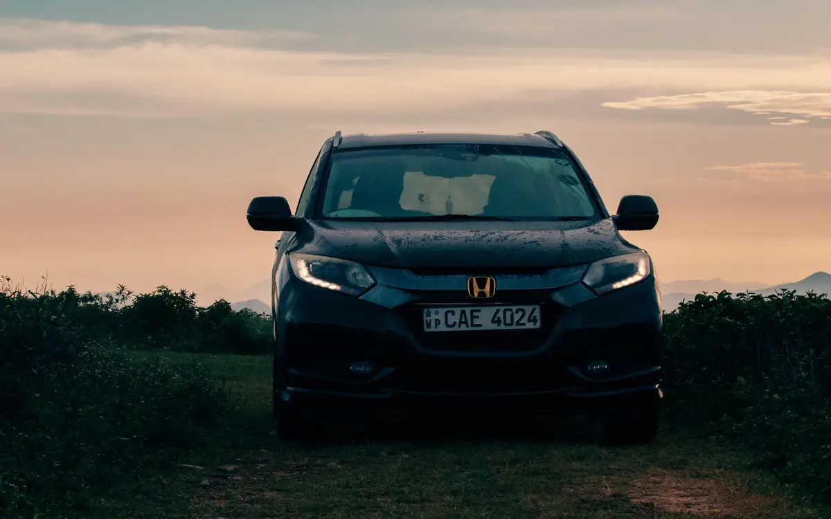 A car parked on a hill road at dusk